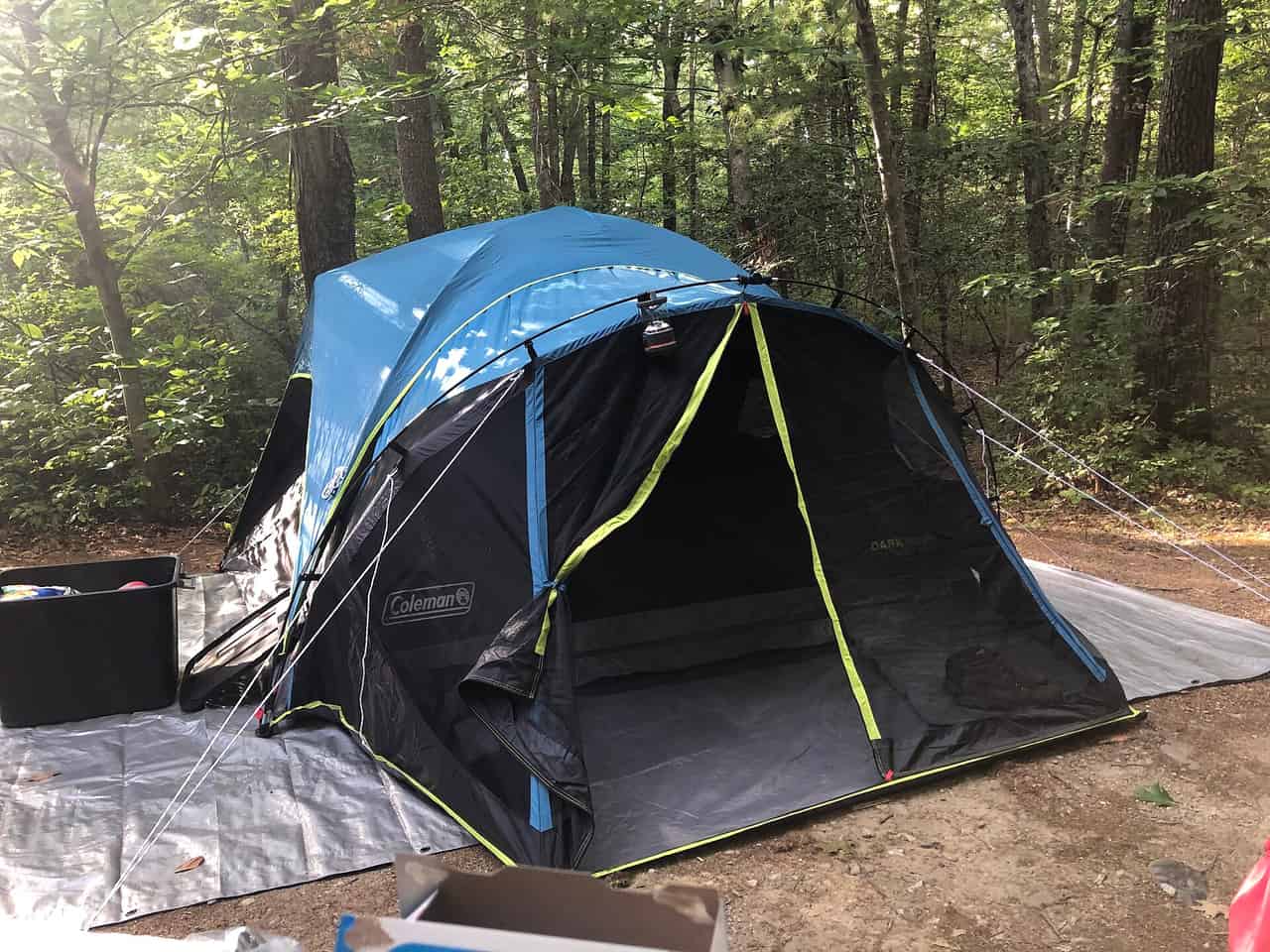 Camping gear laid out on the ground before being packed into a car